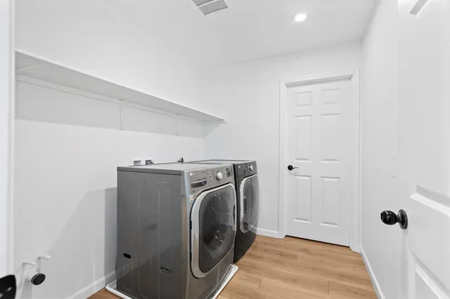 a view of a storage & utility room with a washer dryer