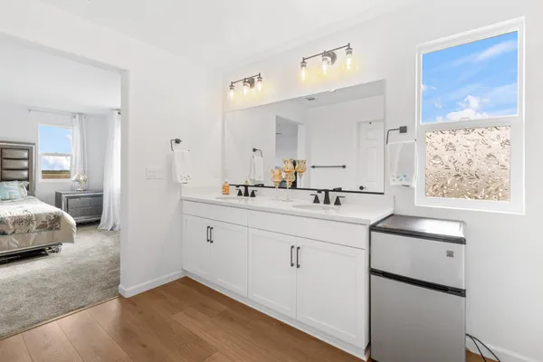 a en suite bathroom with a sink double vanity and a mirror
