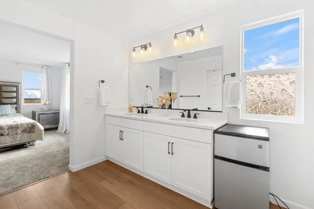 a en suite bathroom with a sink double vanity and a mirror