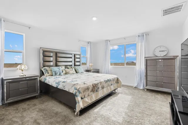 a bedroom with a bed and a dresser