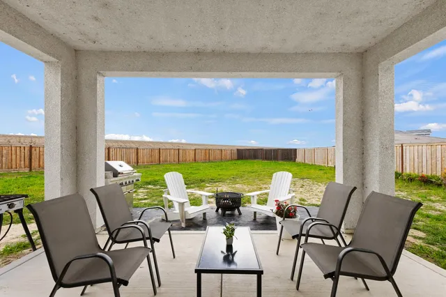 a view of an chairs and table in a patio