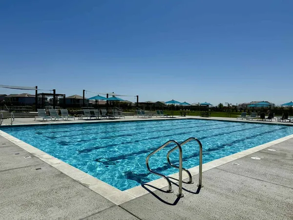 a view of swimming pool with outdoor seating and yard in back