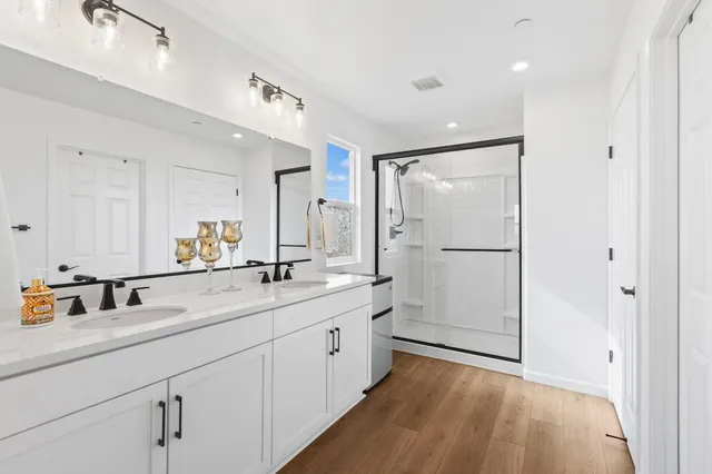 a bathroom with a double vanity sink and mirror