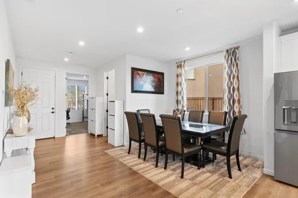 a view of a dining room with furniture and wooden floor