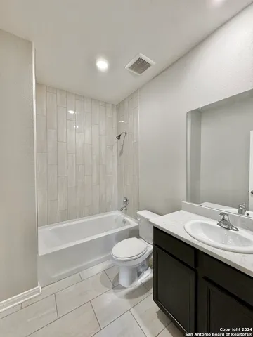 a bathroom with a double vanity sink toilet and shower