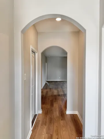 a view of a hallway with wooden floor