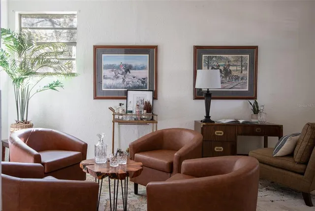 a living room with furniture a couch and a window