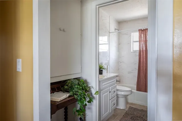 a bathroom with a toilet a sink and shower