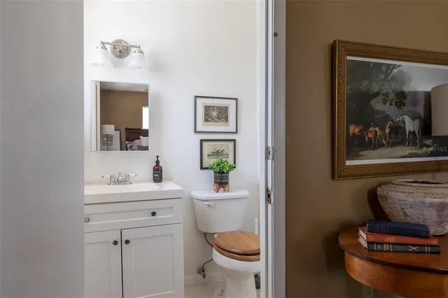 a bathroom with a toilet a sink and mirror