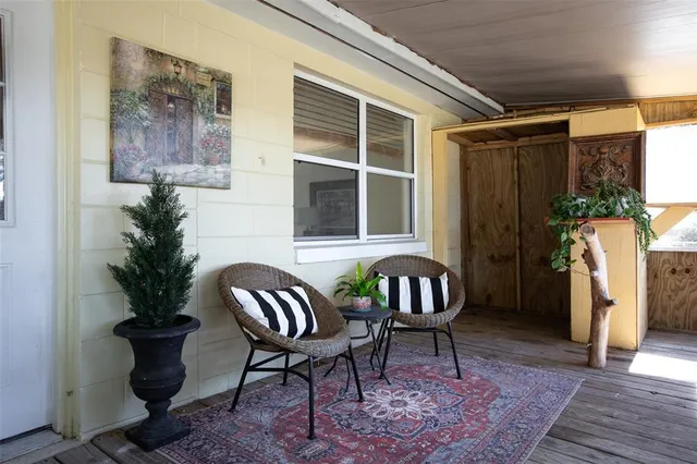 a view of a porch with furniture and a rug