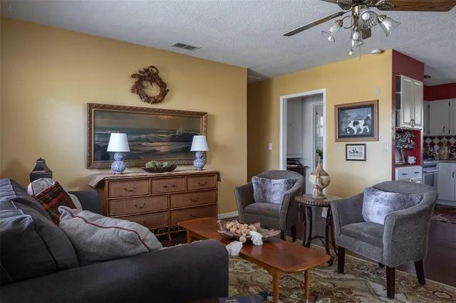 a living room with furniture and paintings on the wall