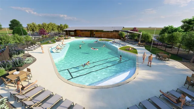 an aerial view of a swimming pool with a yard and outdoor seating