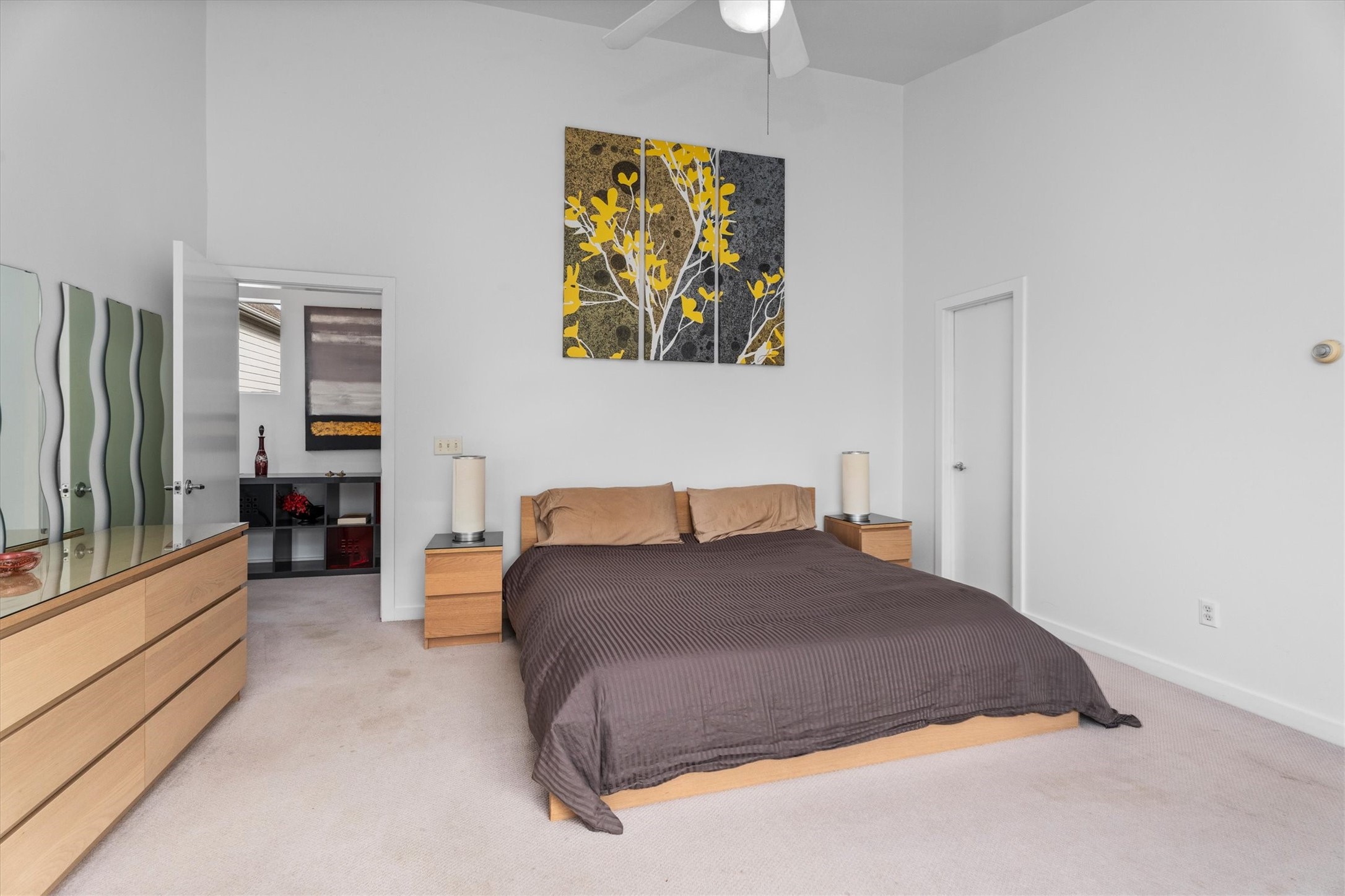 2711 Chenevert Street Houston, TX 77004 - Photo 7 of 33 a bedroom with a large bed and a painting on the wall