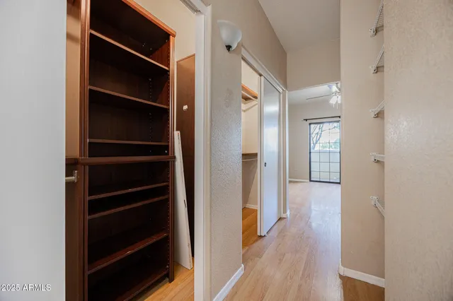 an empty room with a window and a fan