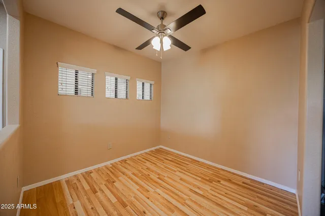 a kitchen with granite countertop a stove cabinets and wooden floor