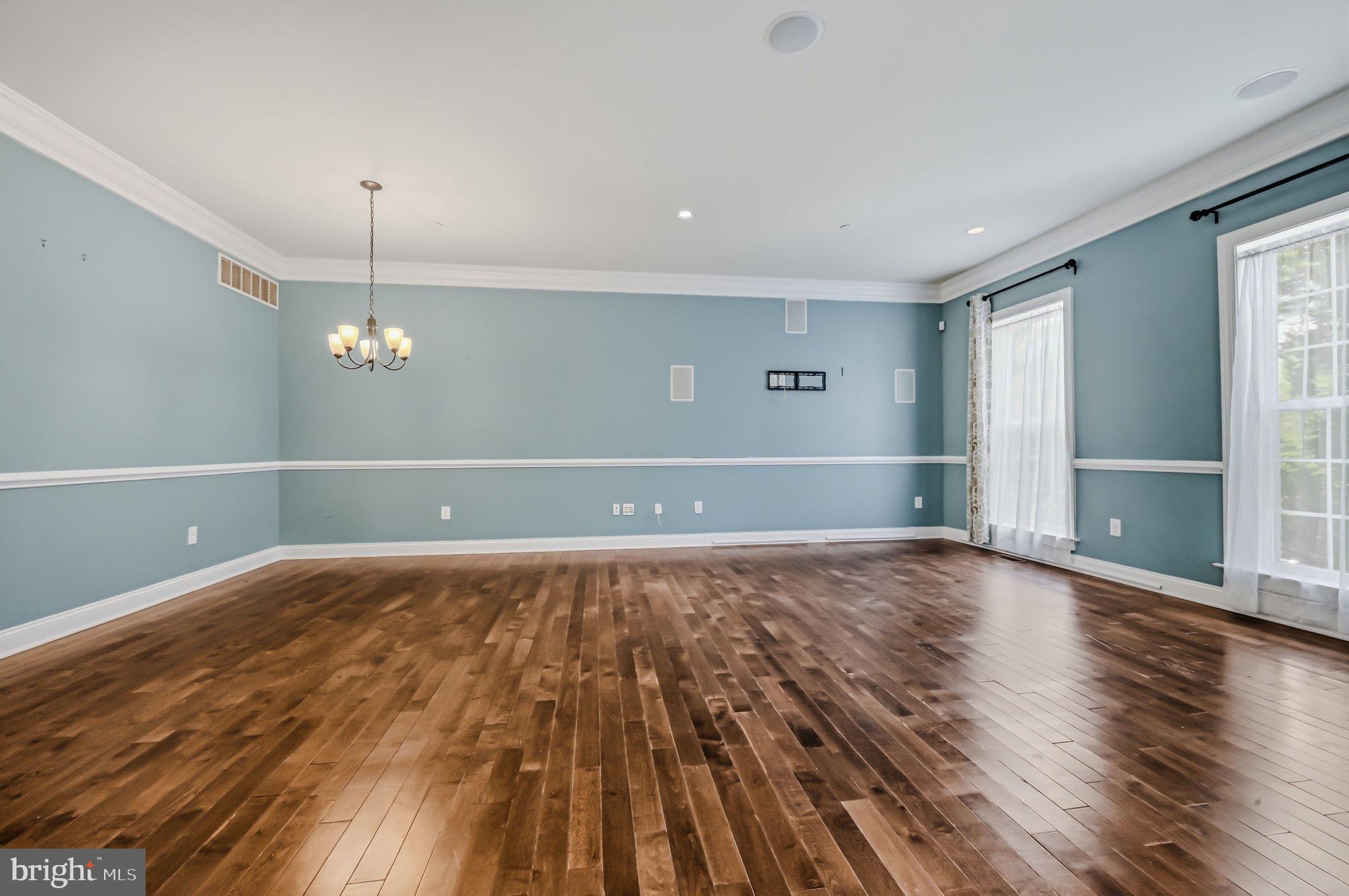 208 Jackdaw Alley, Unit 208 Springfield, PA 19064 - Photo 28 of 49 a view of an empty room with wooden floor and a window