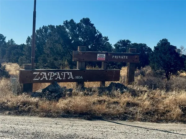 a view of a street sign under a large tree