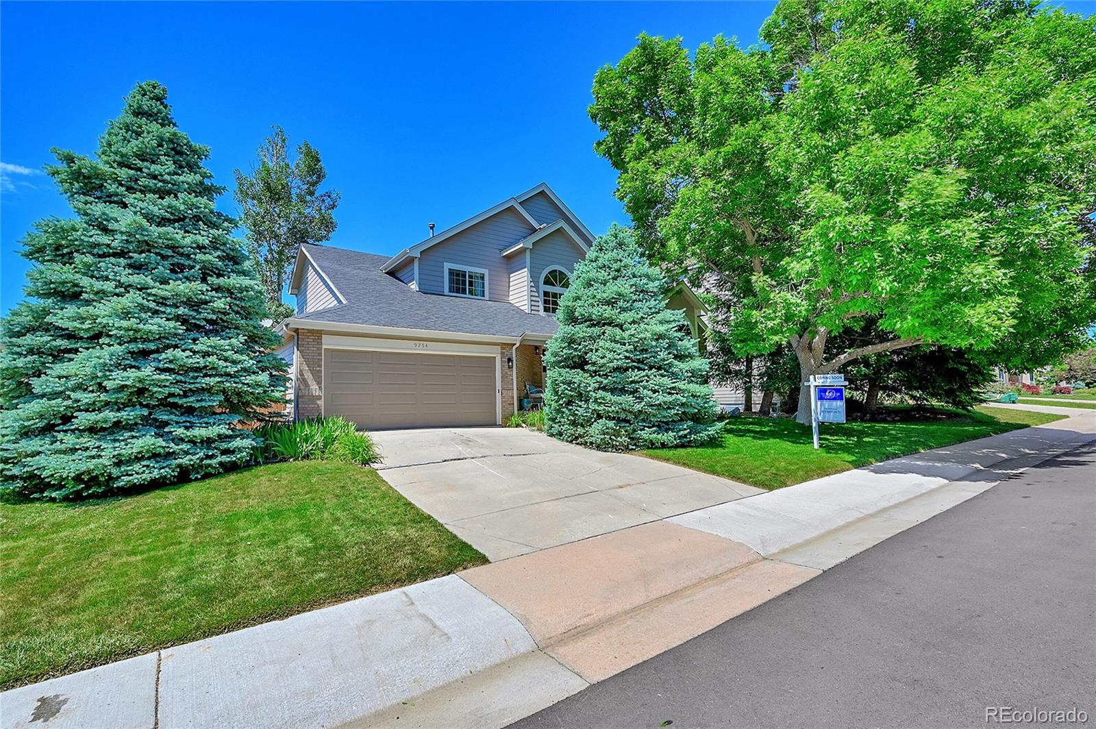 a front view of a house with a yard and a garage