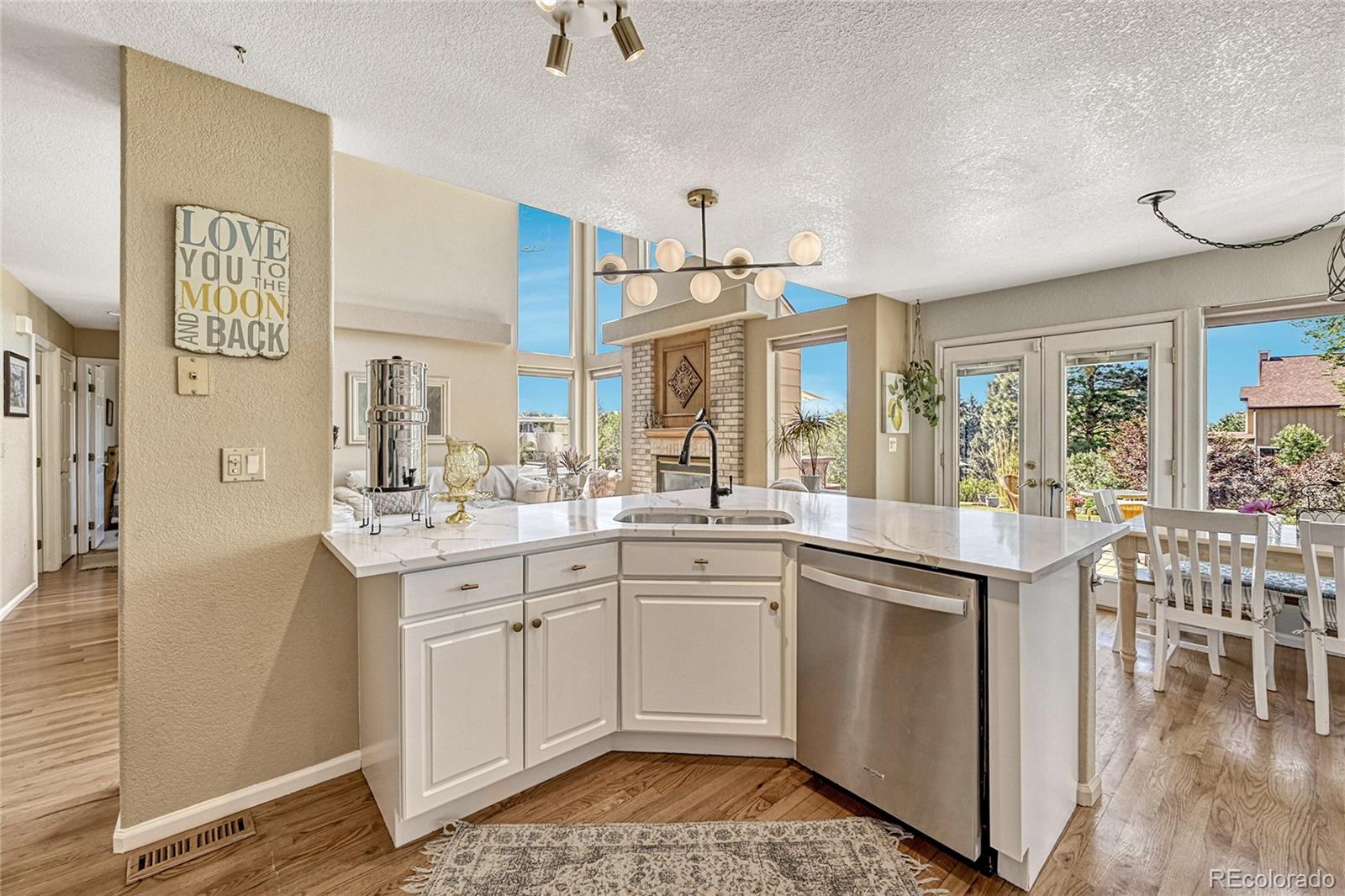 9754 Chanteclair Circle Highlands Ranch, CO 80126 - Photo 12 of 47 a kitchen with a sink cabinets and window