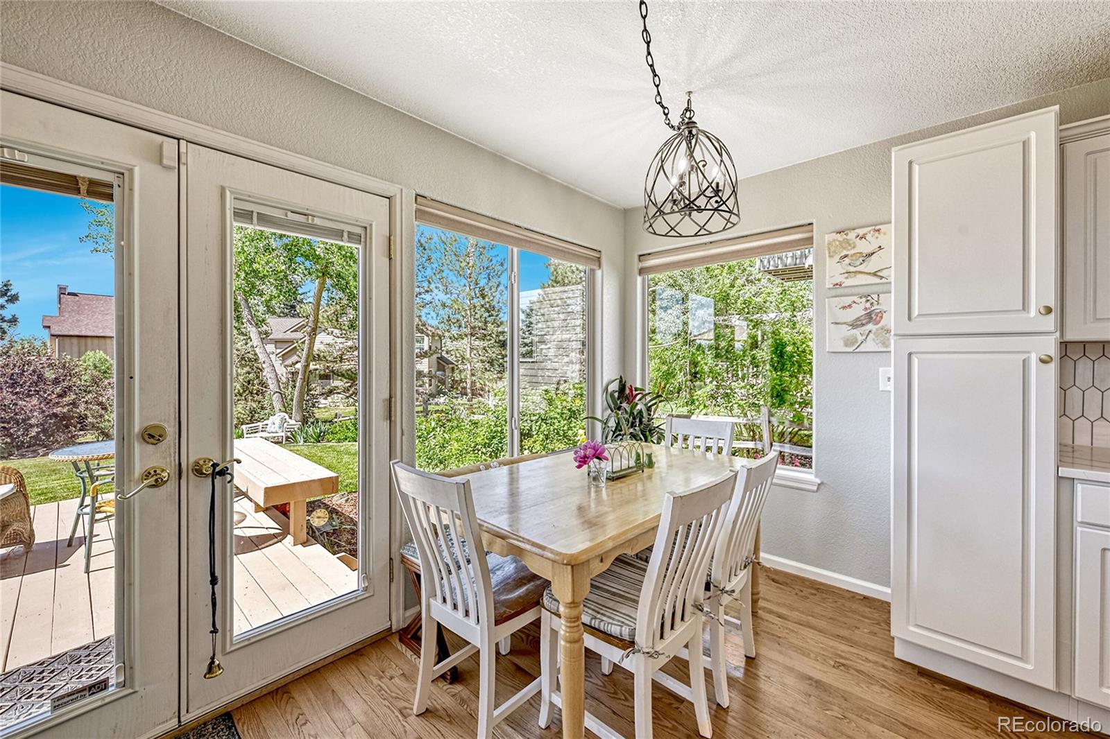 9754 Chanteclair Circle Highlands Ranch, CO 80126 - Photo 13 of 47 a view of a dining room with furniture window and wooden floor