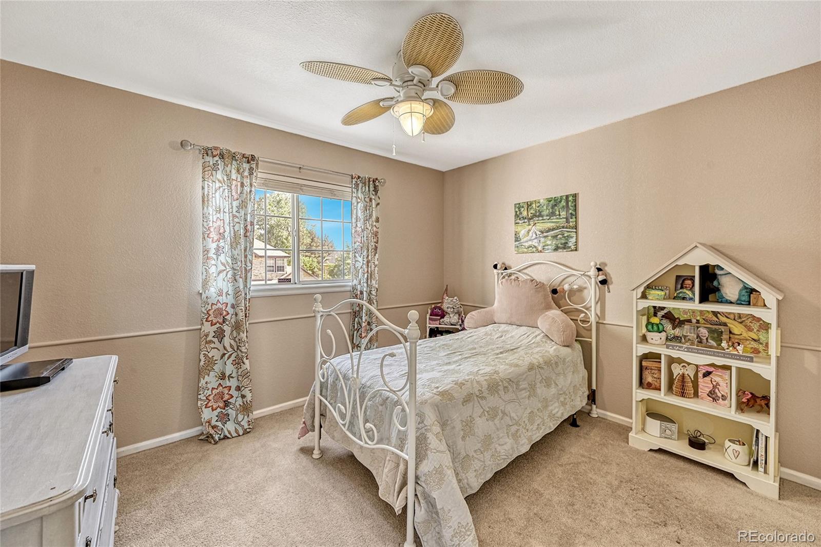 9754 Chanteclair Circle Highlands Ranch, CO 80126 - Photo 26 of 47 a bedroom with a bed and a window
