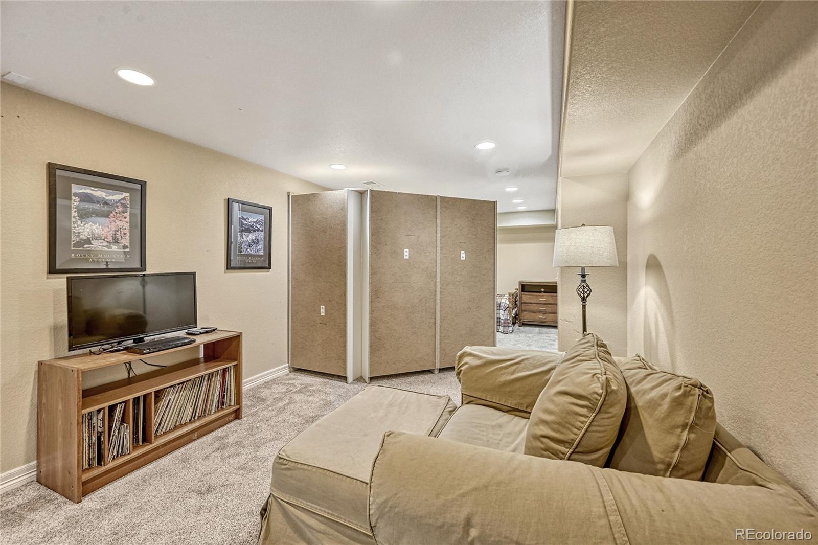 9754 Chanteclair Circle Highlands Ranch, CO 80126 - Photo 31 of 47 a bedroom with a bed and a flat screen tv