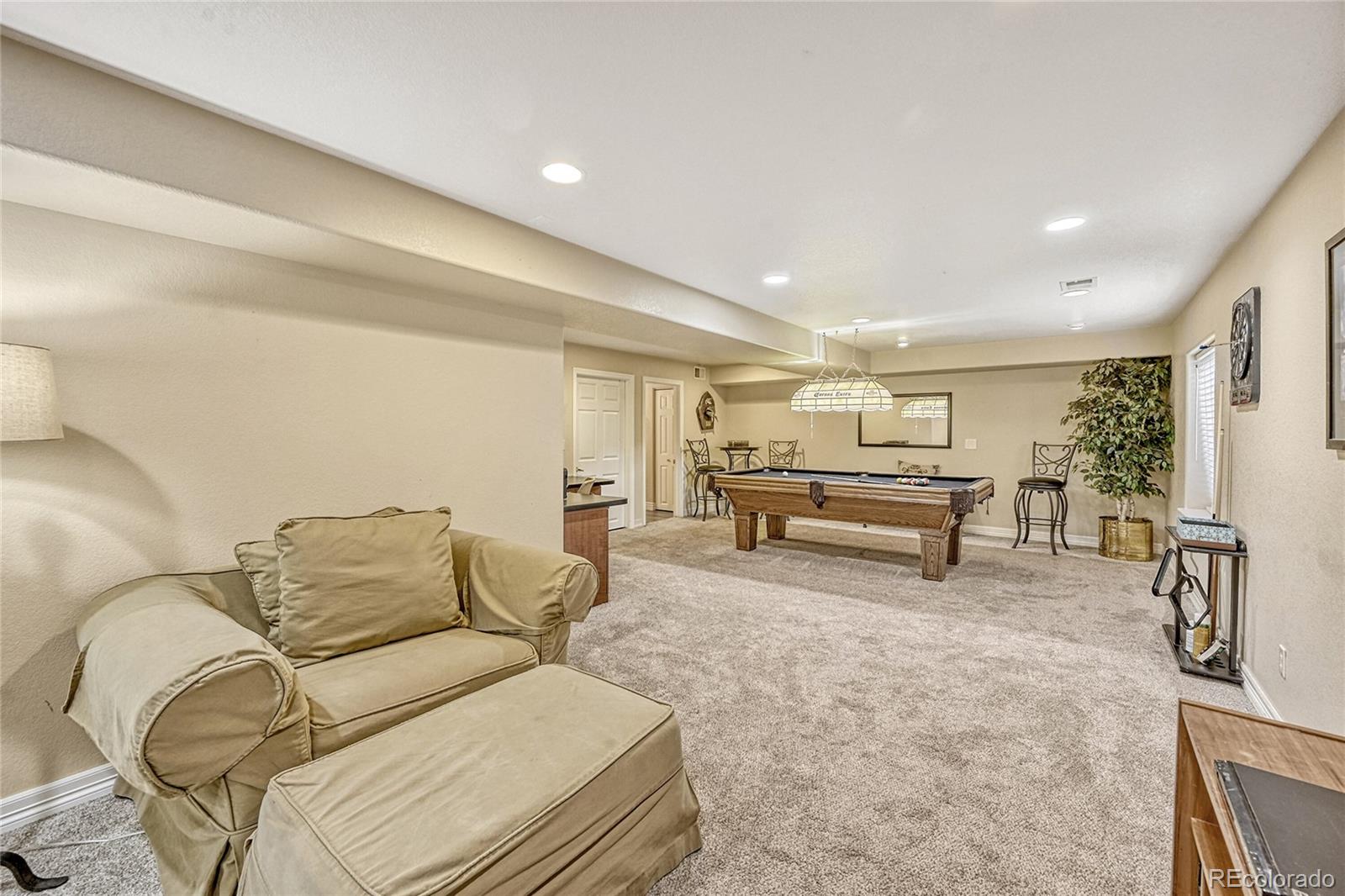 9754 Chanteclair Circle Highlands Ranch, CO 80126 - Photo 32 of 47 a spacious bedroom with a bed and ceiling fan