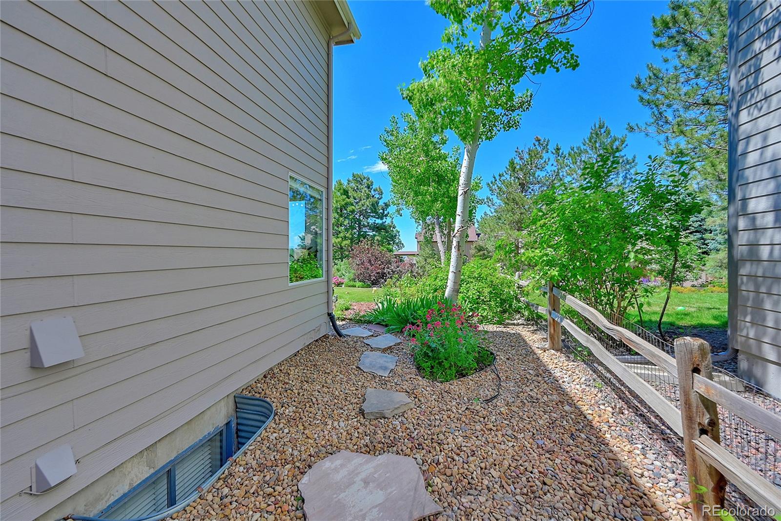 9754 Chanteclair Circle Highlands Ranch, CO 80126 - Photo 35 of 47 a view of a backyard with plants and a patio