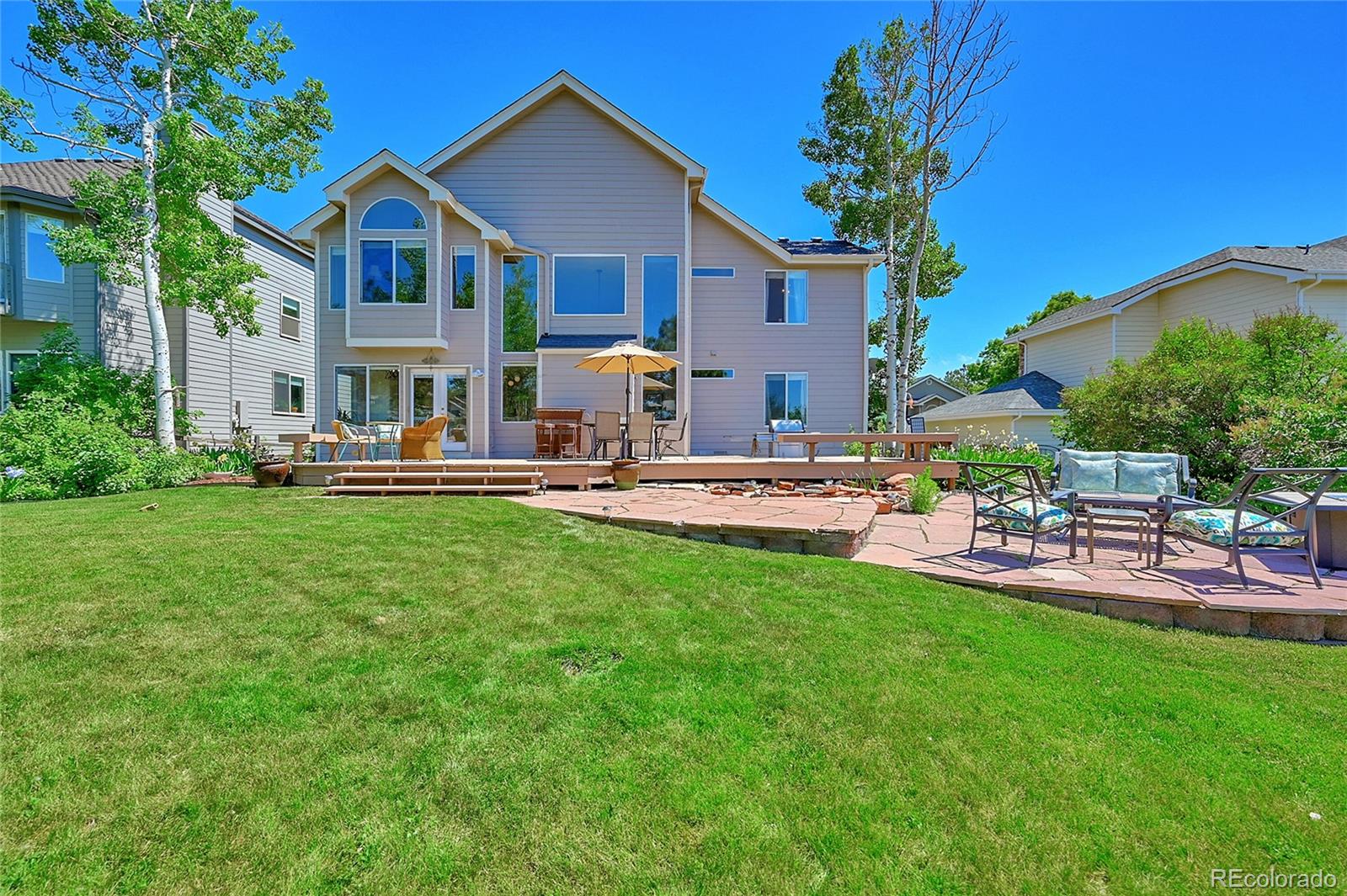 9754 Chanteclair Circle Highlands Ranch, CO 80126 - Photo 38 of 47 a front view of a house with patio and sitting area
