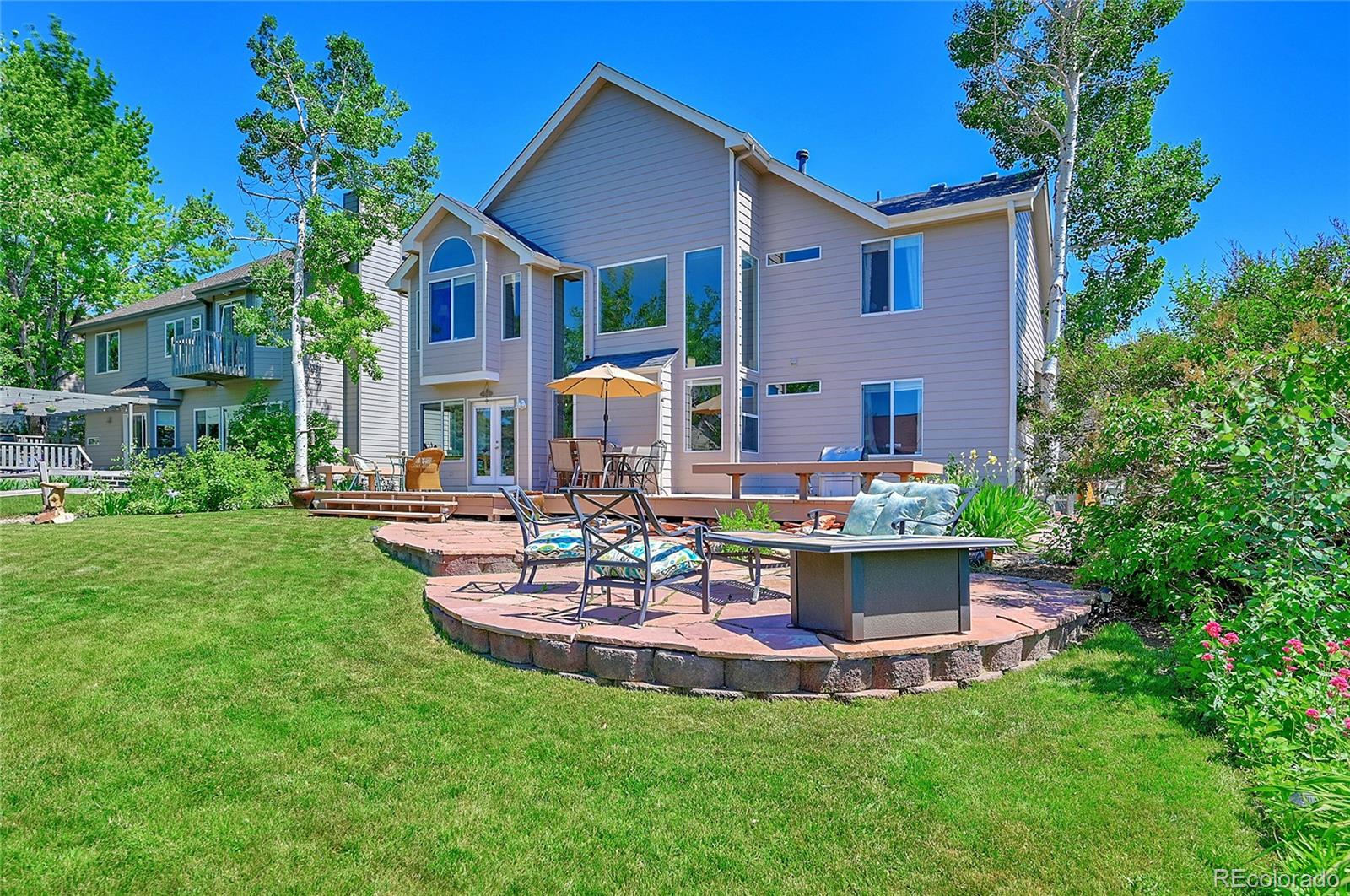 9754 Chanteclair Circle Highlands Ranch, CO 80126 - Photo 39 of 47 a front view of house with a garden and patio