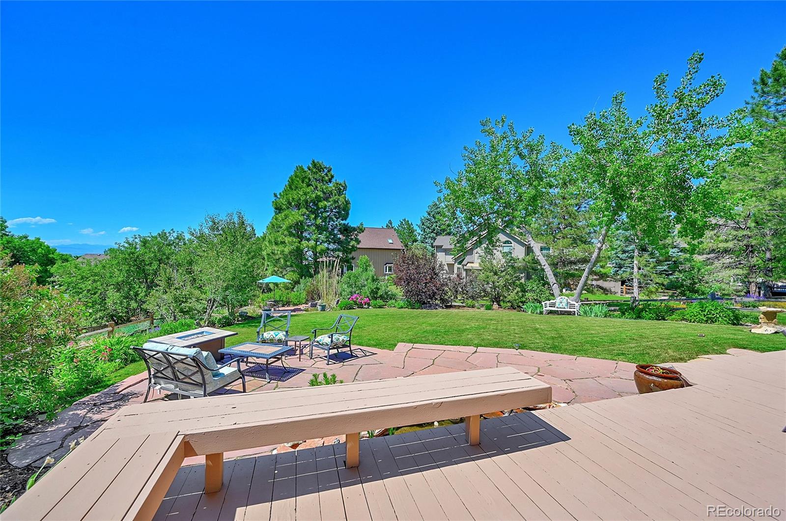 9754 Chanteclair Circle Highlands Ranch, CO 80126 - Photo 41 of 47 a view of a patio with couches plants and large tree