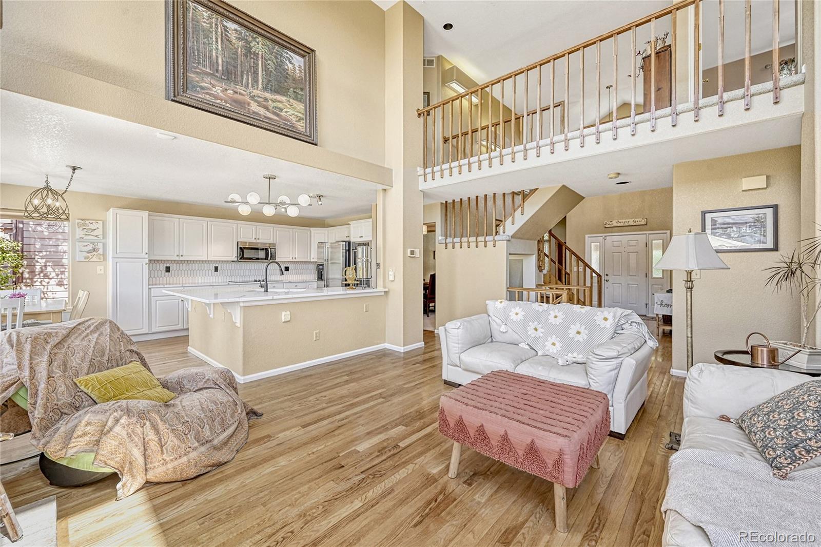 9754 Chanteclair Circle Highlands Ranch, CO 80126 - Photo 8 of 47 a living room with furniture and a kitchen view
