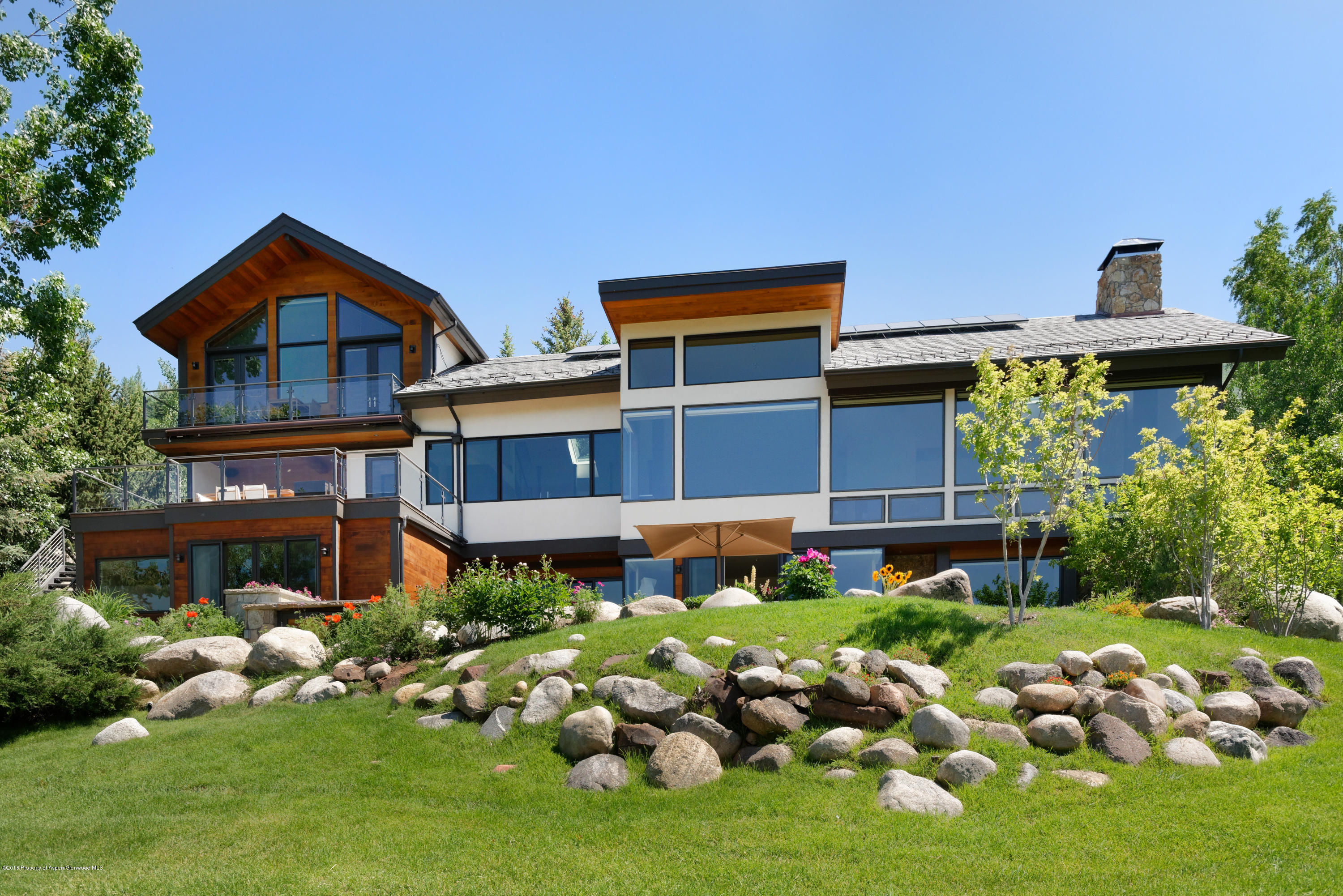 274 Draw Drive Aspen, CO 81612 - Photo 19 of 32 a front view of a house with a small yard and potted plants