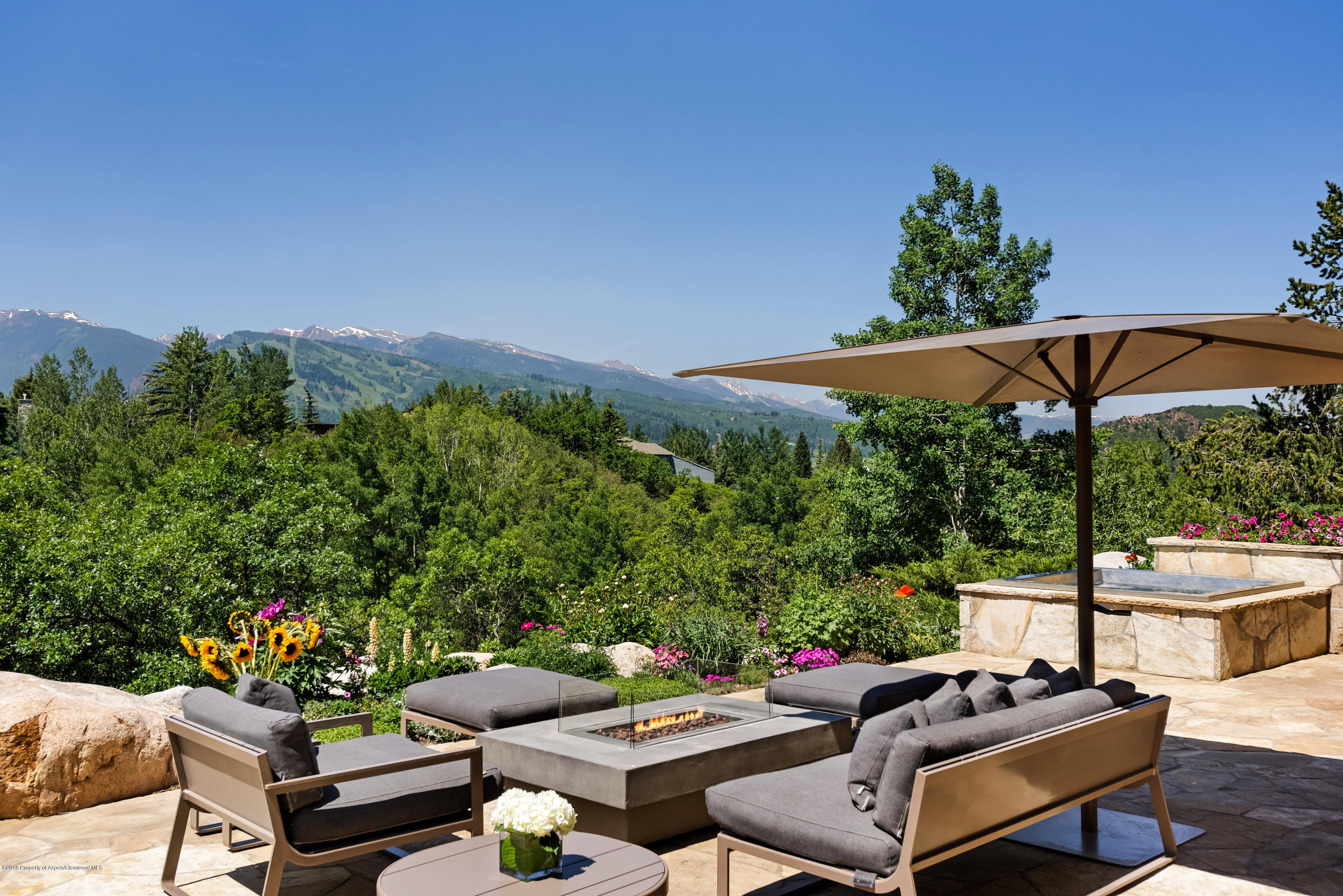 274 Draw Drive Aspen, CO 81612 - Photo 21 of 32 a patio with patio a table and chairs under an umbrella