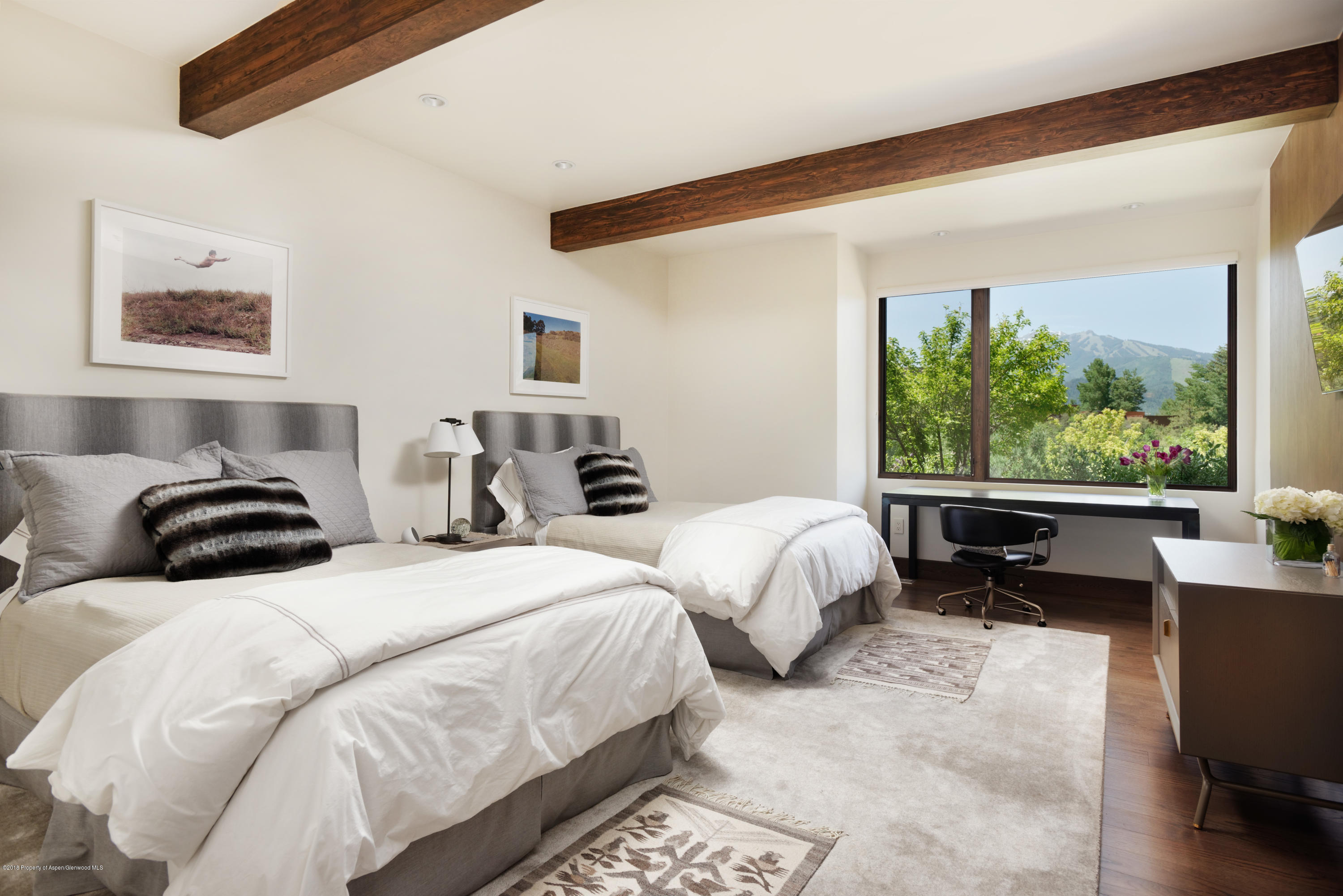 274 Draw Drive Aspen, CO 81612 - Photo 25 of 32 a bedroom with a bed and a large window