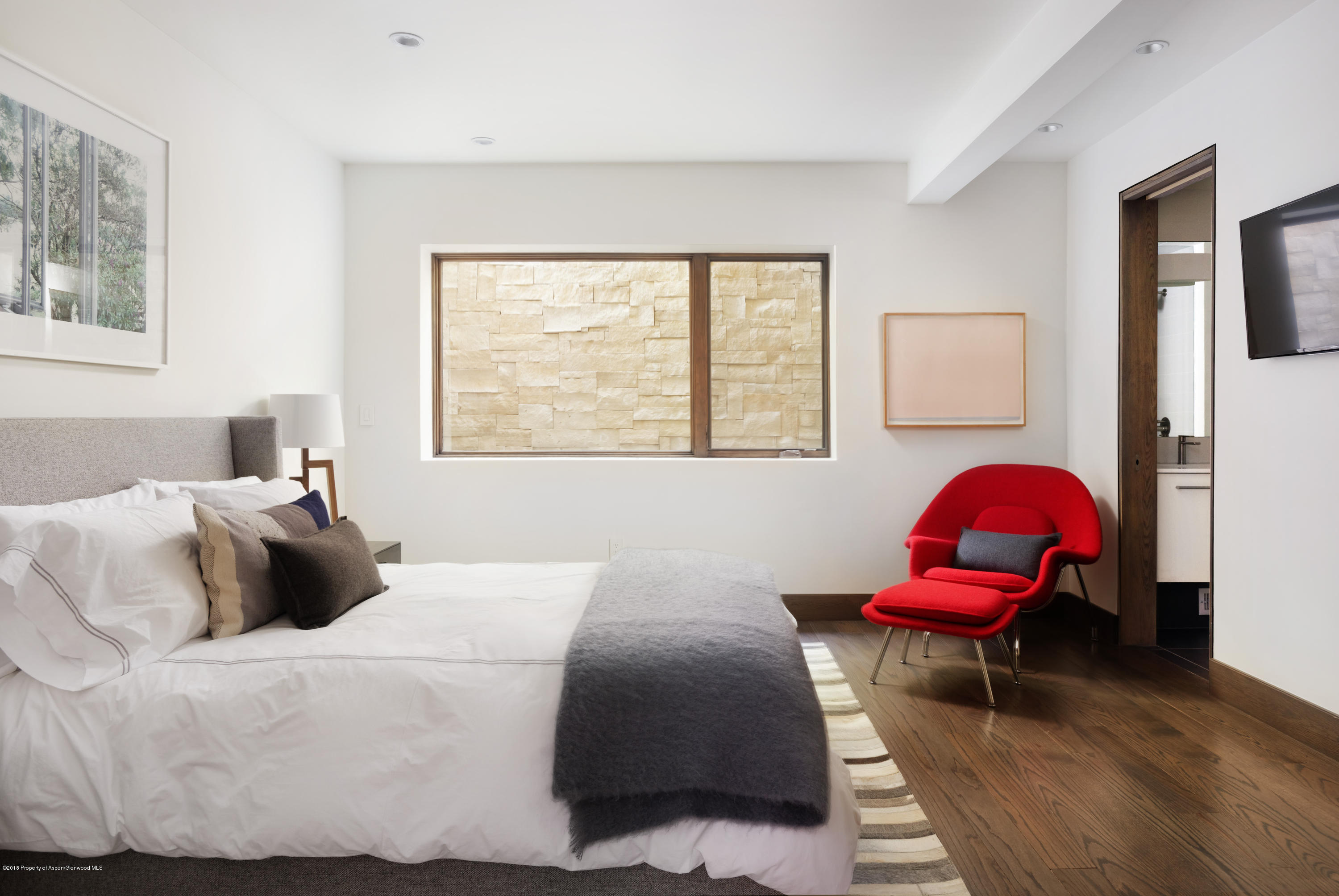 274 Draw Drive Aspen, CO 81612 - Photo 31 of 32 a bedroom with a bed and wooden floor