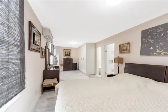 a bedroom with a bed couch and a window