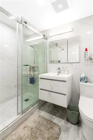 a bathroom with a sink toilet and shower