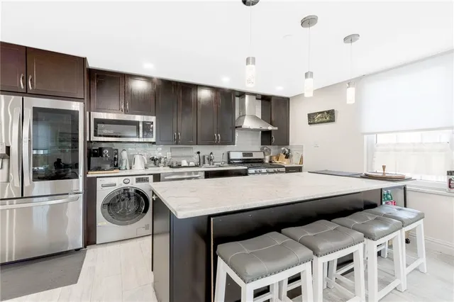 a kitchen with a stove a sink and a refrigerator
