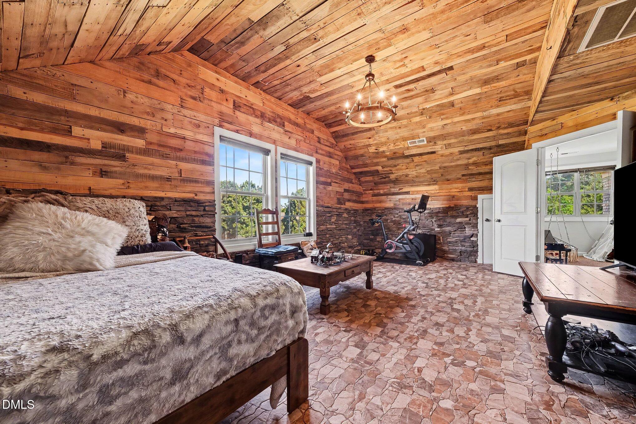 4000 Banks Stone Drive Raleigh, NC 27603 - Photo 36 of 60 a bedroom with a bed and wooden floor