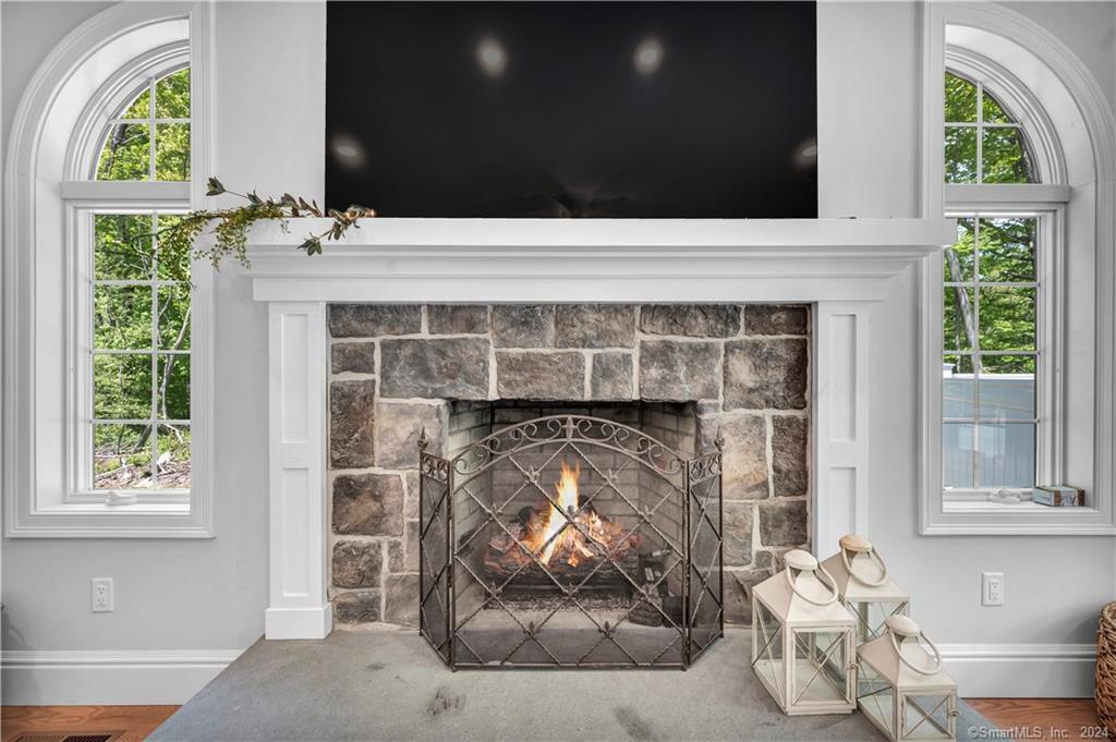 38 Opening Hill Road Madison, CT 06443 - Photo 7 of 11 a living room with a fireplace and a large window