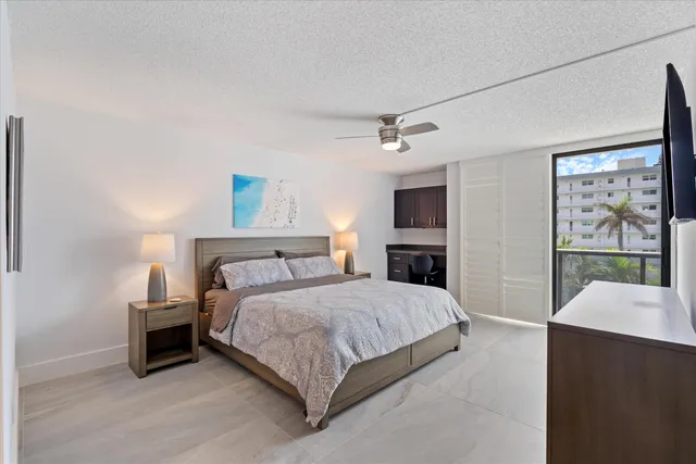 a bedroom with a bed a fireplace and windows