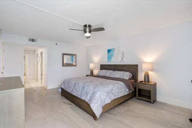 a bedroom with a bed and ceiling fan