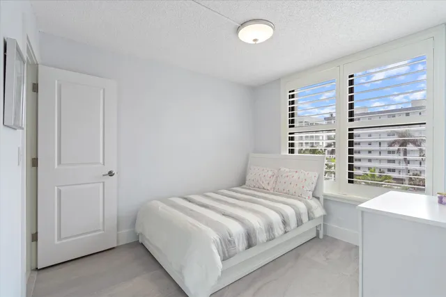 a bedroom with a large bed and a large window