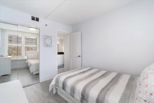 a bedroom with a bed and glass door