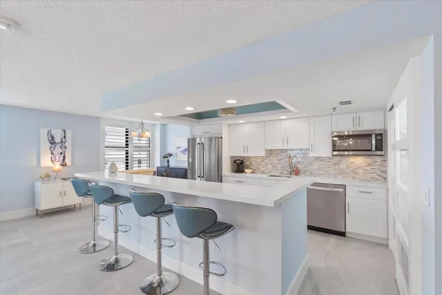 a kitchen with stainless steel appliances kitchen island granite countertop a sink and cabinets