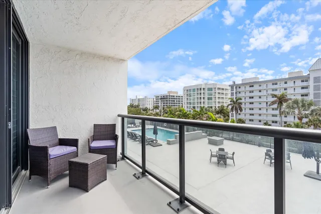 a view of hotel from balcony with seating space