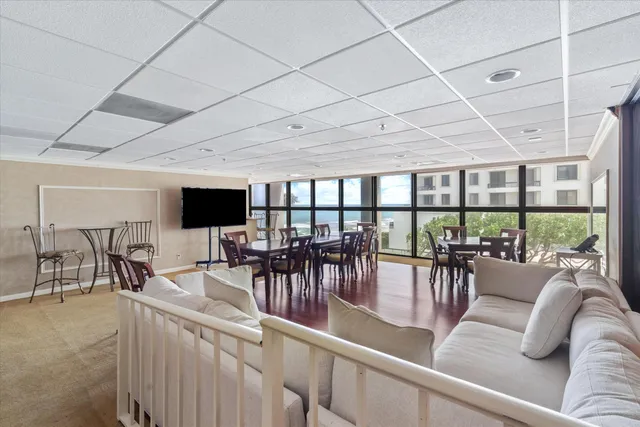 a view of a porch with furniture and floor to ceiling window