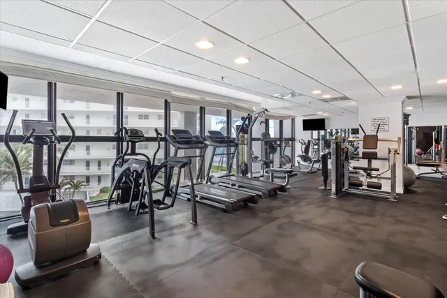a room with gym equipment and windows