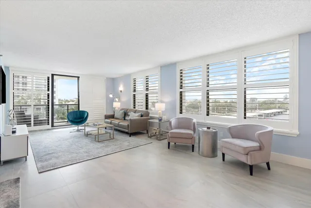 a living room with furniture and large windows